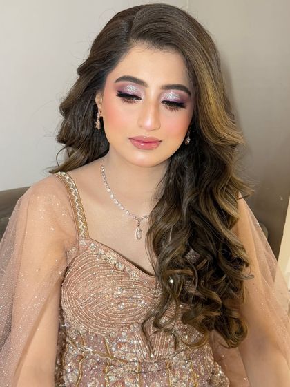 The eye makeup for this look is a beautiful blend of soft shimmer and deeper tones in the crease for definition.