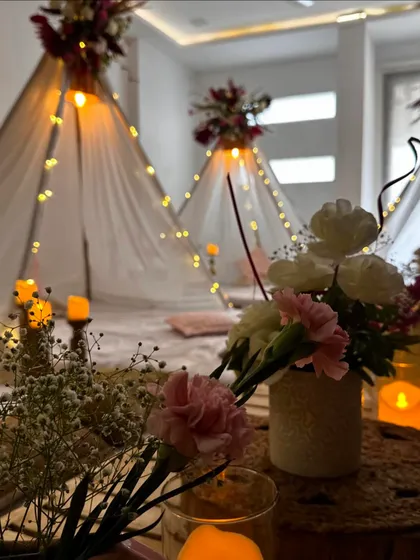 A close up shot of the details from our luxury slumber party setup. Fresh carnations, baby's breath, and the warm glow of candles create a soft and romantic ambiance for a perfect girls' night in.