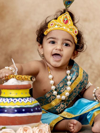 This little Krishna is having a great time with his pot of 'butter'. His joyful, open-mouthed smile is infectious.