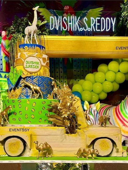 The themed cake for the neon jungle party is a multi-tiered masterpiece, perfectly matching the vibrant decor.