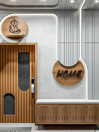 This entryway unit is designed for modern Bangalore apartments. It combines a ventilated shoe cabinet with a comfortable seating bench, a small niche for a Ganesha idol, and decorative wall paneling with integrated lighting.