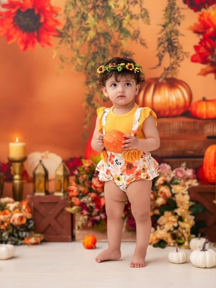 Standing tall in the pumpkin patch. This is a great way to capture a new milestone, like standing, within a fun and creative theme.