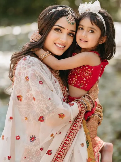 A precious moment between the bride and a young family member during her Mandap Mahurat ceremony.