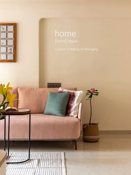 A home is a feeling of belonging. This shot captures the essence of our design philosophy, creating a comfortable and personal space with a plush sofa and warm details.
