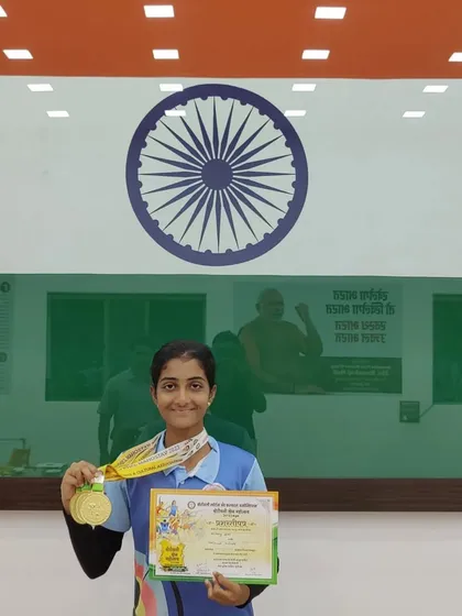 An archer from our academy shows off her three gold medals won at the Borivali Krida Mahotsava's Archery Competition.
