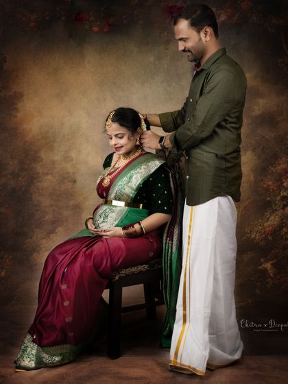 A sweet, intimate moment as the partner helps adorn her hair with flowers. This captures the beauty of traditional rituals and partnership.
