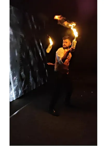 Our fire flair bartending is a showstopper. This dramatic performance, captured in the dark, highlights the excitement and "wow" factor we can bring to your wedding reception or corporate party.