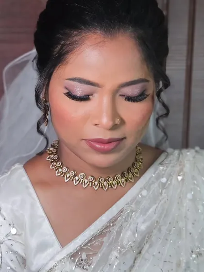 A close-up of a bride's eye makeup for her Christian wedding. The soft pink shimmer adds a romantic touch.
