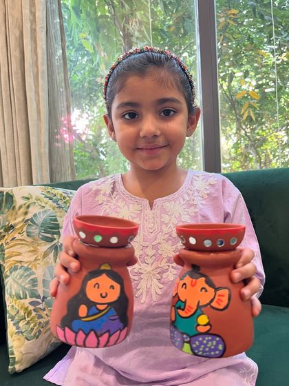 This student did a fantastic job painting her pair of decorative pots for the festival of lights.