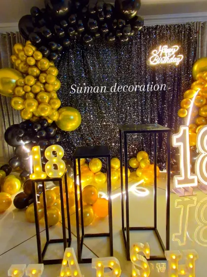 A closer look at the 18th birthday black and gold setup, focusing on the dessert stands and marquee numbers.