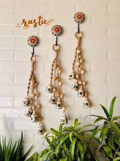 A beautiful display of our 'Symphony Chimes' in the 'Rustic' variant. The natural jute twine and wooden beads give these chimes a warm, earthy feel, perfect for a bohemian decor style.