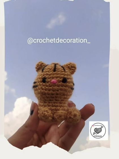 This little crochet tiger amigurumi is perfect as a pocket-sized friend. The hand-stitched stripes and pink nose give it a unique and charming personality.