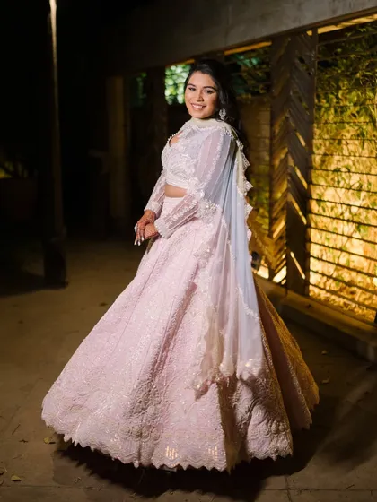 A full-length shot of the bride's stunning pink engagement gown. The look is ethereal and princess-like.