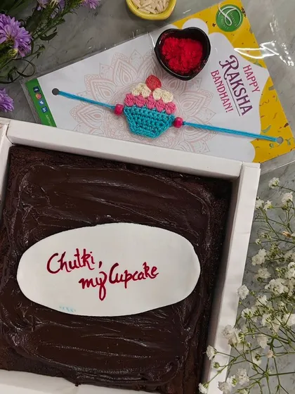 Another one of our popular Rakhi hampers, this one with a cute cupcake crochet Rakhi and a brownie that says "Chutki, my cupcake". We love creating these personalized, sweet combinations.