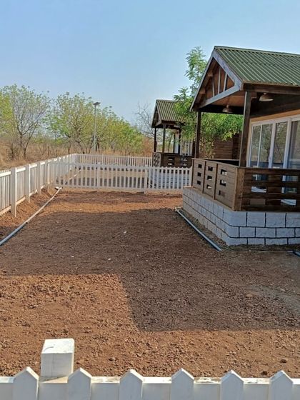 This is the 'before' shot of the farmhouse yard, a blank canvas of prepared soil ready for transformation.