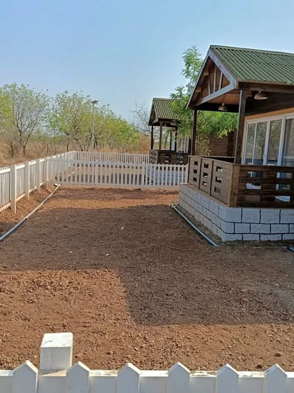 This is the 'before' shot of the farmhouse yard, a blank canvas of prepared soil ready for transformation.