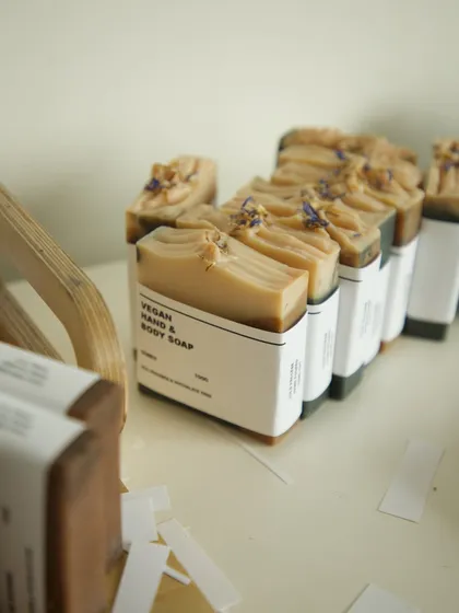 A lineup of soaps with their minimalist paper labels.