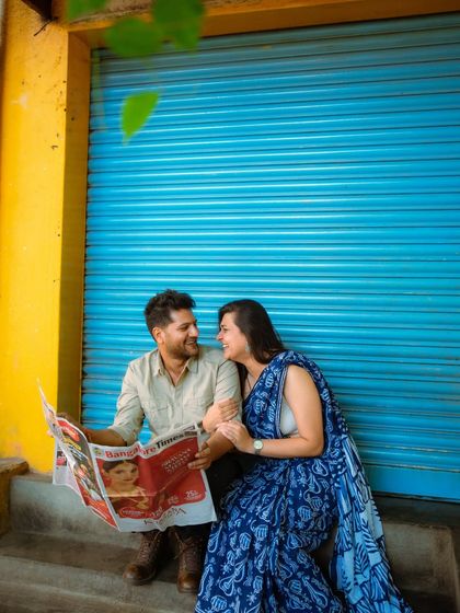 Capturing the simple joy of sharing a moment together. This urban photoshoot uses a bold, colorful backdrop to highlight the couple's connection.