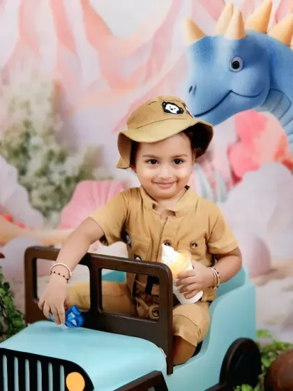 A tiny explorer in a safari hat drives a jeep through a prehistoric jungle, complete with friendly dinosaurs and woodland creatures.