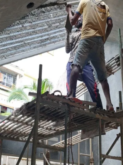 A close-up of artisans working on the intricate plaster details of the Brick House, a process that requires immense patience and skill.