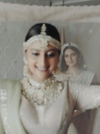 A moment of sisterly love, captured through the bride's veil. The younger sister looks on with admiration as the bride gets ready. I love finding these creative angles to capture intimate family moments that are full of emotion.