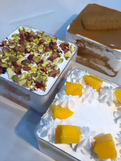 A beautiful shot of my three fusion cake tubs: Rose Pista with pistachios and rose petals, classic Lotus Biscoff, and seasonal Fresh Mango.