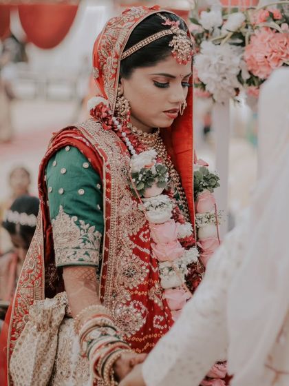 The bride during the wedding ceremony, her expression serene and focused. This photo captures the solemnity and beauty of the wedding vows.
