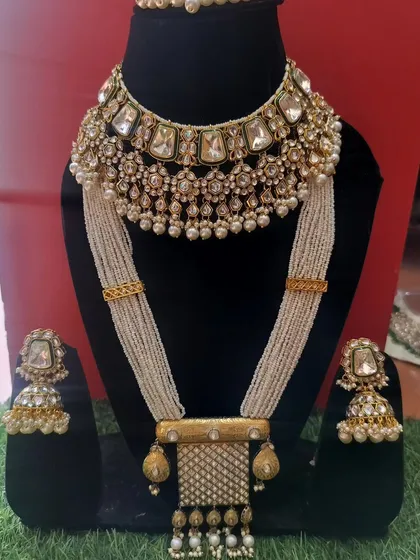 A unique bridal set with a Kundan choker and a long, beaded necklace, offering a modern twist on a traditional style.
