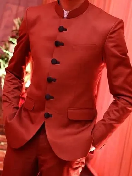 This is the kind of sharp, confident look I deliver. A client looking dapper in a custom-tailored vibrant red Jodhpuri suit, perfectly fitted for a wedding celebration.