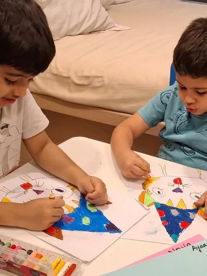 Two brothers work side-by-side, each creating their own version of the class project. Our sessions encourage individual creativity in a shared, supportive environment.