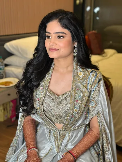 A side profile showing the beautiful flow of her soft curls. This hairstyle is timeless and perfect for a reception.