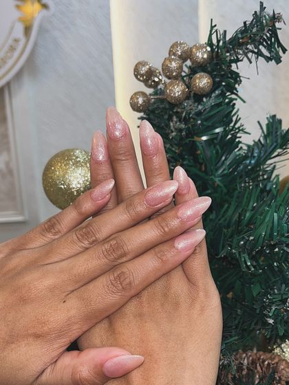A still shot of the sheer pink gel nails, pictured against our festive Christmas decor.