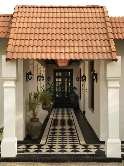 The entrance corridor of the cafe, where the strong graphic pattern of the floor and the repetition of columns create a powerful sense of perspective.