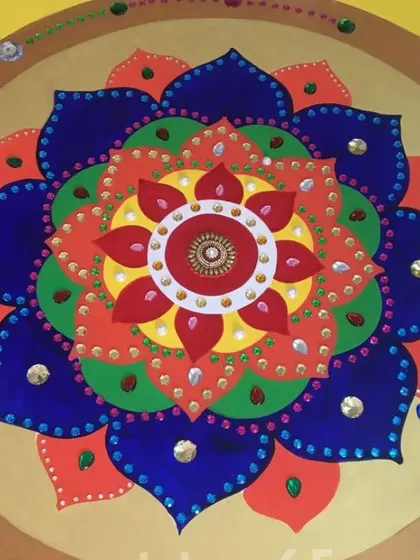 A detailed view of a multi-colored mandala design. We create these calming and spiritual patterns for wall hangings or as part of larger installations, perfect for creating a peaceful atmosphere in homes or yoga studios.