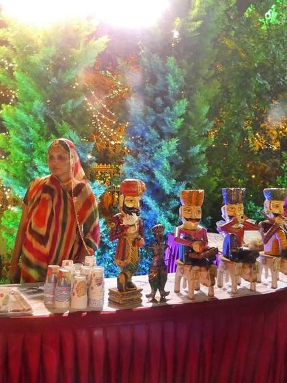 A themed counter featuring traditional Indian puppets and a live buttermilk station. These creative touches make the dining experience more engaging and memorable for guests.