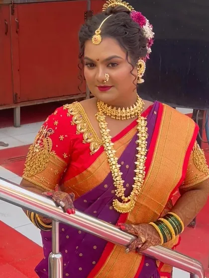 A full-length shot of the bride, looking elegant and poised. Her makeup and hair are styled to perfection, completing her stunning traditional look.
