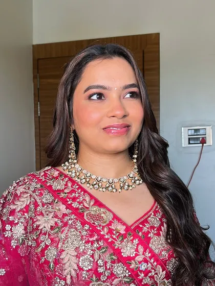 This angle shows the beautiful sheen on her skin and the gloss on her lips. I focus on creating dimension and glow in all the right places for a truly luminous finish.