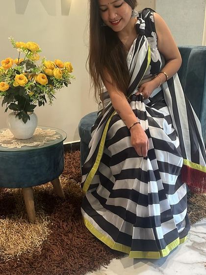 A seated pose in the black and white striped saree. It’s a versatile piece that looks effortlessly chic.