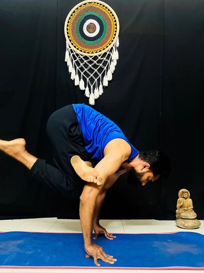 A challenging arm balance that requires a deep twist and core strength. This variation of crow pose is a powerful way to build focus and inner fire.
