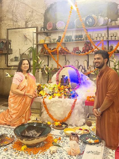 A mother and son share a quiet moment of prayer in front of our Ganesha pandal. The festival brings together generations in shared devotion.