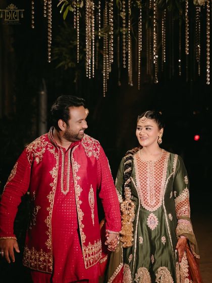 The happy couple at their Punjabi-themed Mehendi. The bride's traditional paranda and the groom's vibrant attire perfectly matched the energetic and colorful decor of the day.