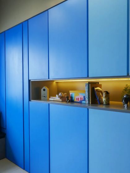 The wardrobe in the young adult's room features an ombre blue effect and a built-in niche. I also added a ledge seating area by the window with storage underneath for games.