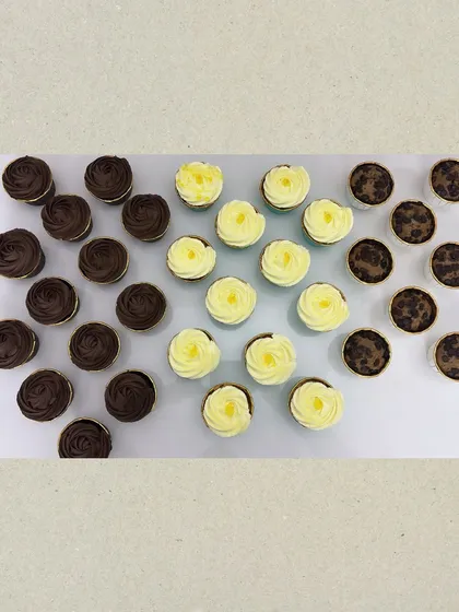 A beautiful flat lay of my assorted cupcakes, including rich chocolate, lemon-filled vanilla, and chocolate chip muffins. It's a tough choice when they all look this good.