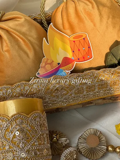 When the theme of the Lohri party is yellow, I create gifts that radiate warmth. This hamper features yellow velvet potlis and other coordinated items, all beautifully arranged.