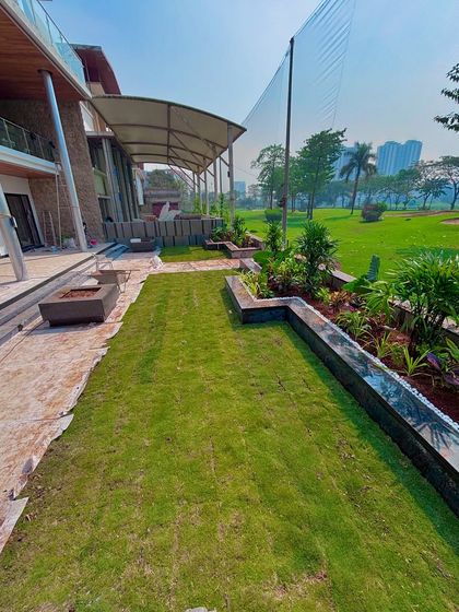 A wider view of the Lodha villa landscape during the final stages. The lawn is in, the planters are full, and the space is taking shape.