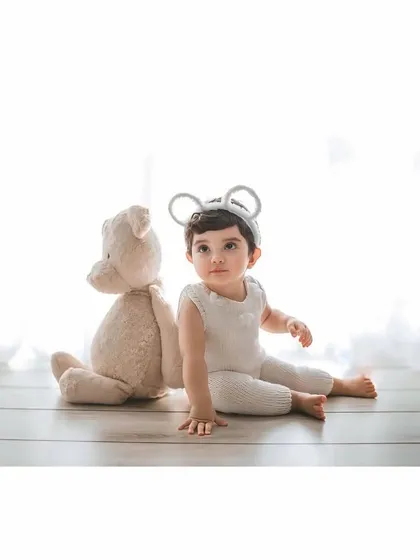 A confident little mouse crawling towards the camera. The simple, bright studio setting is perfect for capturing these important developmental milestones.
