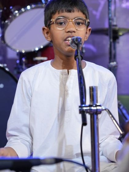 A young student in our Carnatic vocal program, learning the art of performance from an early age.