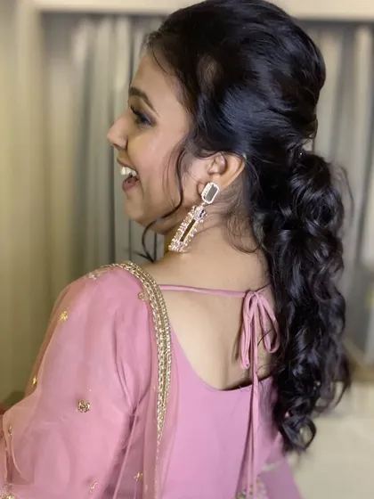 A candid shot showing the movement and beauty of this ponytail hairstyle. It's a practical yet glamorous choice for an evening event.