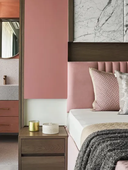A view of the master bedroom's bedside, highlighting the custom nightstand and the seamless transition to the ensuite bathroom.