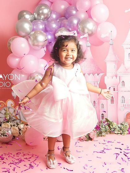 Twirling in her beautiful dress, this little girl is having the time of her life during her princess-themed photoshoot.